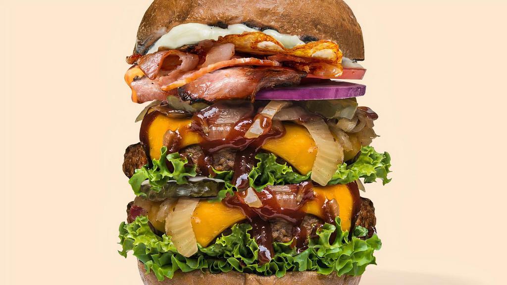 Smoky BBQ Burger (Ultimate) · Double thick and succulent pan-grilled mushroom patties with smoky sweet BBQ sauce, with added vegan cheese, vegan bacon and vegan egg, coupled with layers of garden-fresh lettuce, onion, tomato and pickle, topped with creamy vegan garlic aioli.