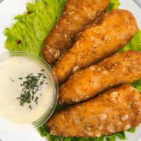Chik'n Tenders · Crunchy, juicy and warm vegan chicken tenders with a side of fresh lettuce.