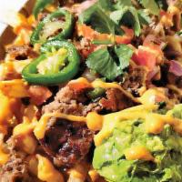 Carne Asada Fries · Impossible bits, The Uncreamery nacho cheese, pico de gallo, guacamole & caramelised jalapeño.