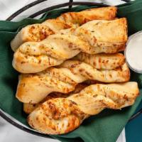Garlic Parmesan Twists · Our twists are freshly rolled with our signature dough, flavored then baked to perfection an...