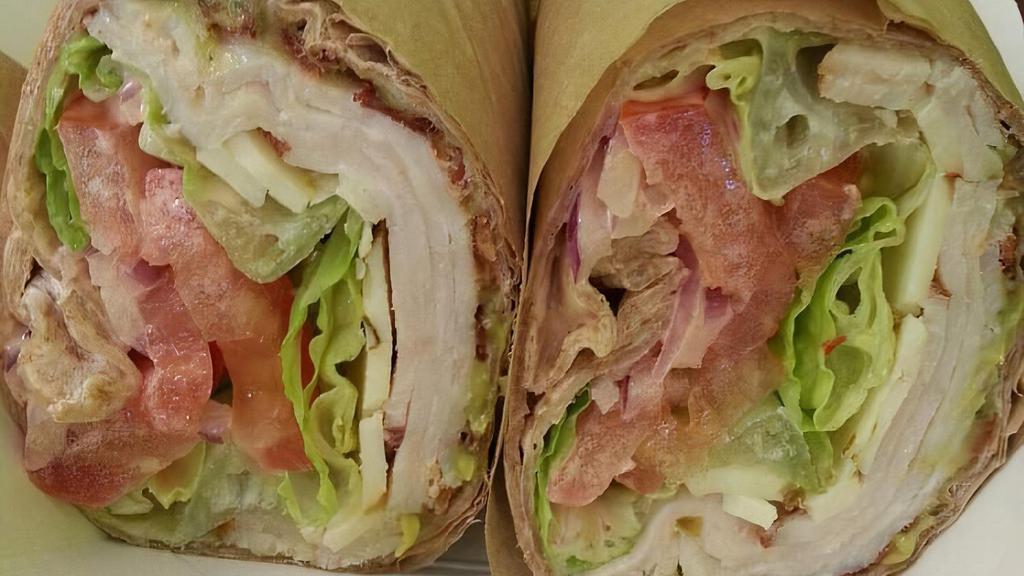 Zesty Turkey Wrap · Tortilla, guacamole, peppered turkey, spring mix, tomatoes, red onion, bell pepper, Mexican cheese, chipotle ranch.