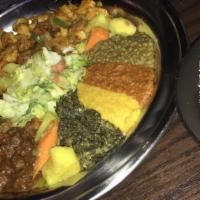 Vegetarian Combination · Combined items of temtmo watt, yemisr watt, kik alicha, ye-gomen alicia and brown split peas...