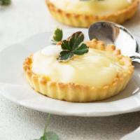 Lemon Curd Tart · Butterfly short dough tart shell filled with lemon curd, sprinkled sugar topping, torched un...