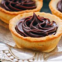 Dark Chocolate Mousse Tartlet · Short dough shell with dark chocolate filling, dusted in with cocoa powder and garnished in ...