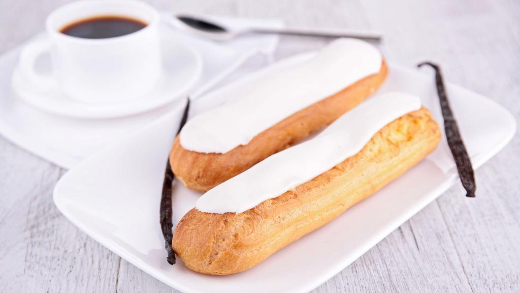 Vanilla Eclair · Fresh pate a choux puff, filled with vanilla custard and dusted with powdered sugar.