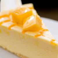 Mango Soleil · Festive dessert made with white cake, mango orange mousse filling, raspberry cream center, w...