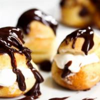 Profiterole Desserts · Fresh white cake with dark chocolate mousse and vanilla cream puff, wrapped in a decorated s...