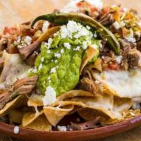 Nachos · Home-made corn chips, melted jack cheese, queso fresco, choice of beans, jalapeños, salsa fr...