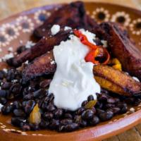 Platanos Maduros · Tropical fried sweet plantains, black beans, crema and queso