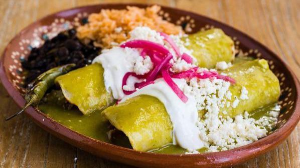 Enchiladas Verdes · Chicken or pork, tomatillo sauce, pickled onion, cilantro, queso and crema. Served with rice and choice of beans.