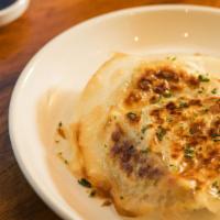 Gyoza · Beef dumplings pan fried, served with spicy soy, sesame oil . Vegan option available.