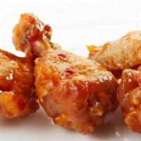 Sweet Chili Wings · Delicious, crispy wings tossed in a sweet Chili sauce and fried to perfection. Served with c...