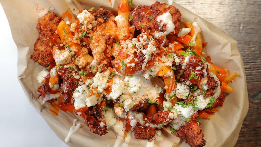 Buffalo Bleu Fries · Buttermilk fried popcorn chicken, on top of our haus fries drizzled with bleu cheese dressing and buffalo sauce then topped with bleu cheese crumbles.