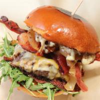 The Bear Burger · Flame grilled halal ground chuck, arugula, applewood smoked bacon, grilled onions, sharp che...