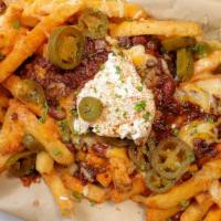 Chili Cheese Fries · Our osito spice rub fries, topped with our halal homeade chili, crema, jalapenos, melted moz...