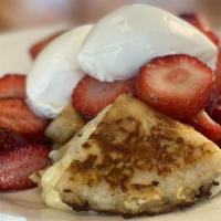 Seasonal French Toast · English muffin stuffed with honey mascarpone cheese.   Battered and grilled.  Topped with fr...