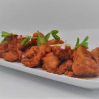 CHICKEN 65 · Since its introduction in 1965, this unique dish made with ginger, cayenne pepper and lime, ...