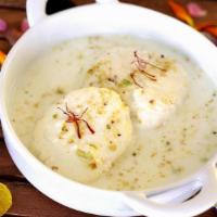 RASMALAI · CHEESECAKE DUMPLING in Malai Sauce served with a garnish of pistachio and almonds