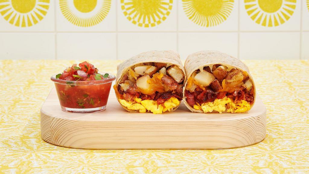 Bacon Breakfast Burrito · Breakfast burrito with scrambled eggs, crispy bacon potatoes and melted cheese.