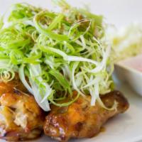 Oven Padak Chicken · Wine and green onion sauce topped with shredded green onions.
