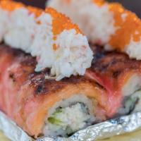 Angry Lion King · CA roll topped with salmon and special sauce & baked. Topped with crab meat and tobiko