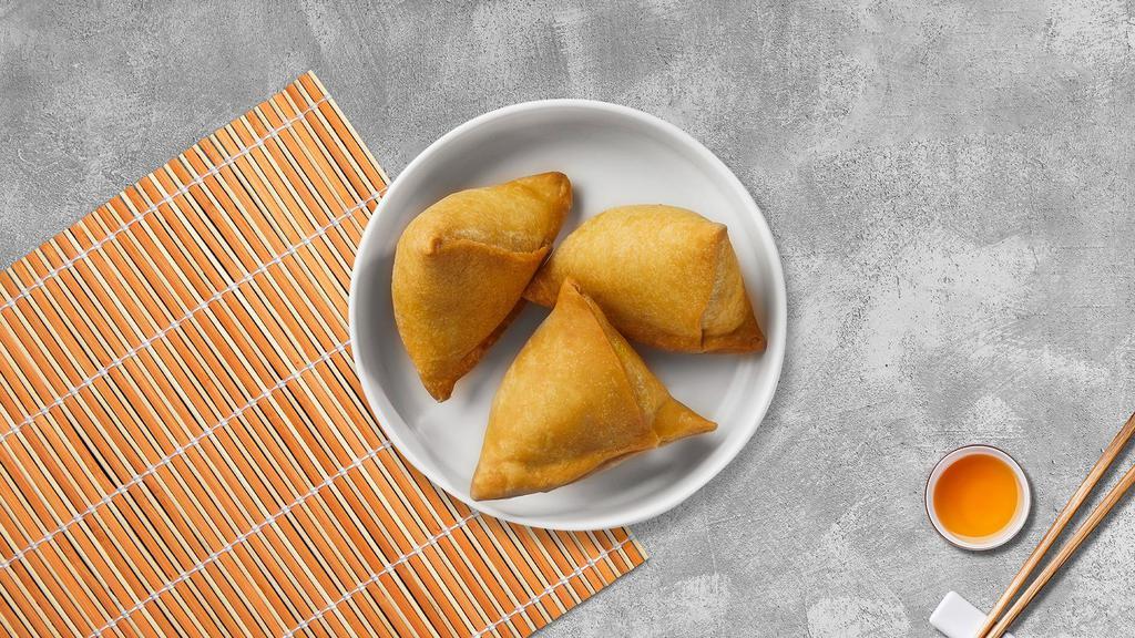 Clucked Samosa · Crispy puff pastry filled with potatoes, onions, and curry powder served with cucumber salad.