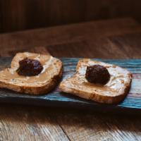 Toast w/ Plum Jam & Reishi Peanut Butter (GF) · Gluten-free toast, reishi peanut butter*, plum jam*, *organic