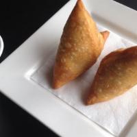 Samosa · Vegan. Two crispy puff pastries filled with potatoes and peas.