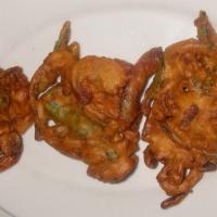 Pakora · Gluten free, vegan. Fresh spinach & onion fritter dipped in chick pea batter & fried.