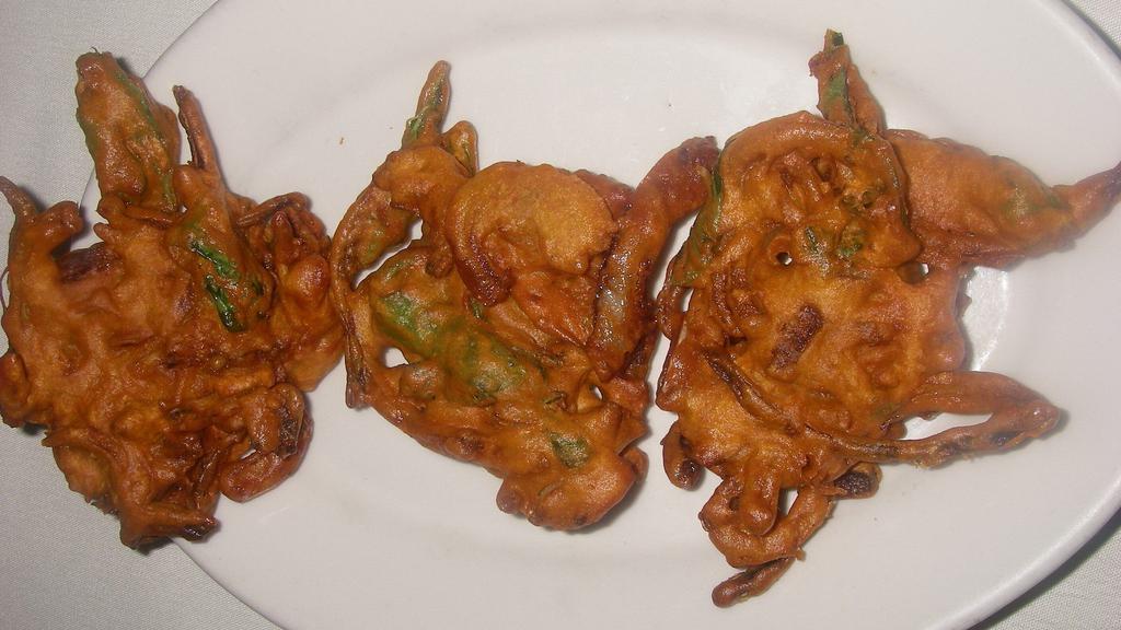 Pakora · Gluten free, vegan. Fresh spinach & onion fritter dipped in chick pea batter & fried.