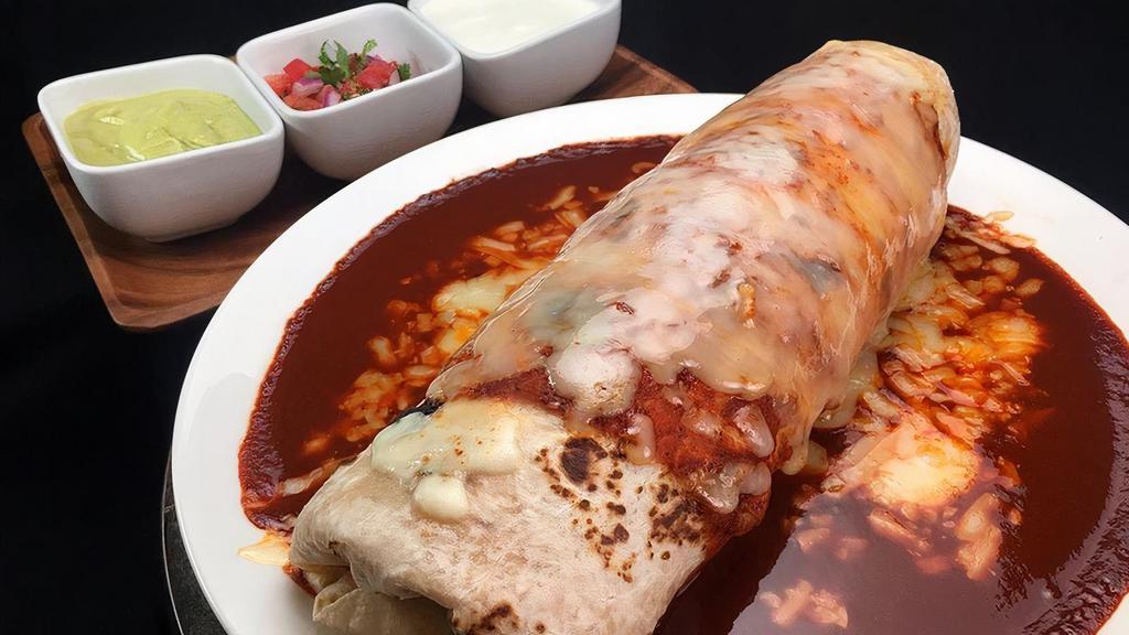 Super Wet Burrito · Beans, rice, green or red  salsa, cheese, sour cream, guacamole, choice of meat (steak, grilled chicken, carnitas, al pastor)