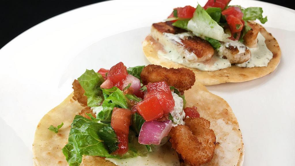 Super Taco Baja Style · lettuce, pico de gallo, seafood cream, green salsa, and either fish or shrimp.