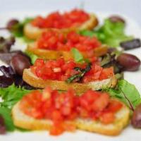 Bruschetta · Toasted slices of bread topped with Roma tomatoes, marinated in olive oil, garlic, and basil.