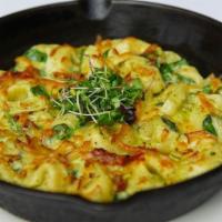 Pesto Tortellini · Sun dried tomatoes, pesto, spinach, topped with smoked Gouda cheese, baked in oven.