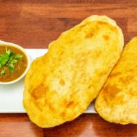 Chole Bhature · Flavorful chickpea curry paired with puffed bread.