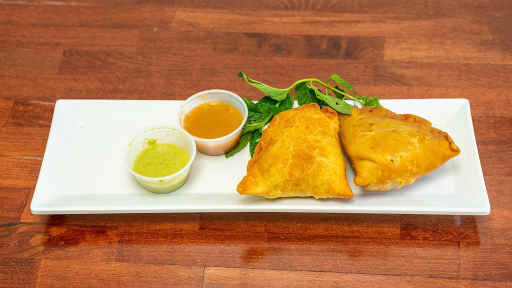Vegetable Samosa (2 Pieces) · Deep-fried pastry with a savory filling of spiced potatoes, onions and peas.
