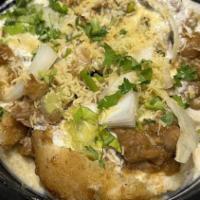 Aaloo Tikki Chaat · Golden fried potato patty, chickpeas topped with chutneys and yogurt.