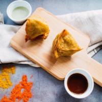 Ground Lamb Samosas · Crispy turnovers filled with minced lamb and served with tamarind and mint chutneys.