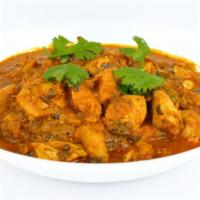 Chicken Curry · Hearty chicken cooked in a savory onion and tomato curry flavored with traditional Indian sp...