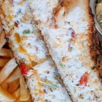 Tuna Melt · Albacore tuna melt served in toasted garlic buttered sourdough bread, chips, coleslaw