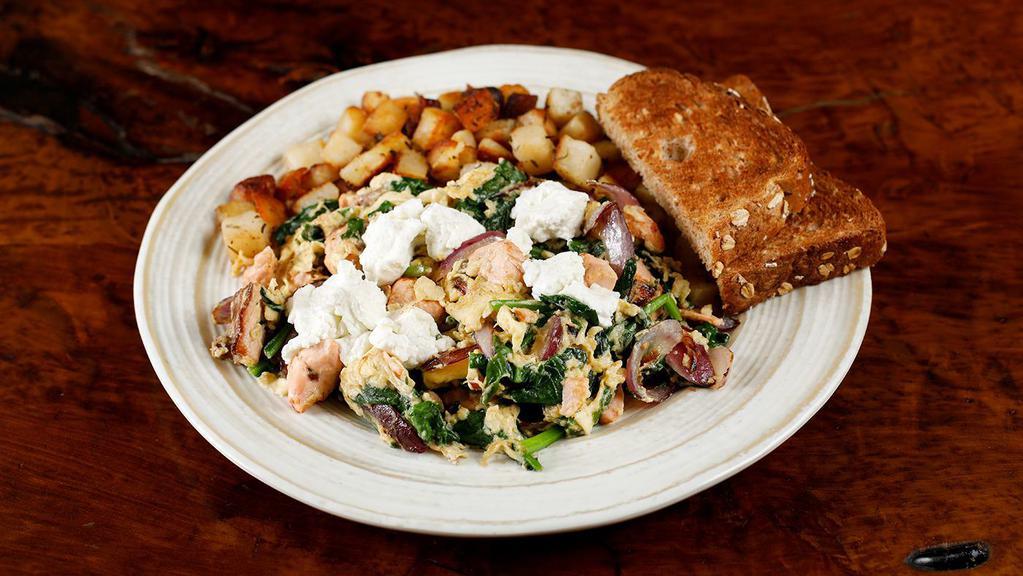 Provence · Fresh salmon with spinach, red onions and goat cheese. Made with three eggs and served with home potatoes and toast.