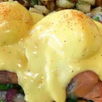 Cote D' Azur Benedict · Smoked salmon, spinach, and red onions with poached eggs on an English muffin with hollandai...