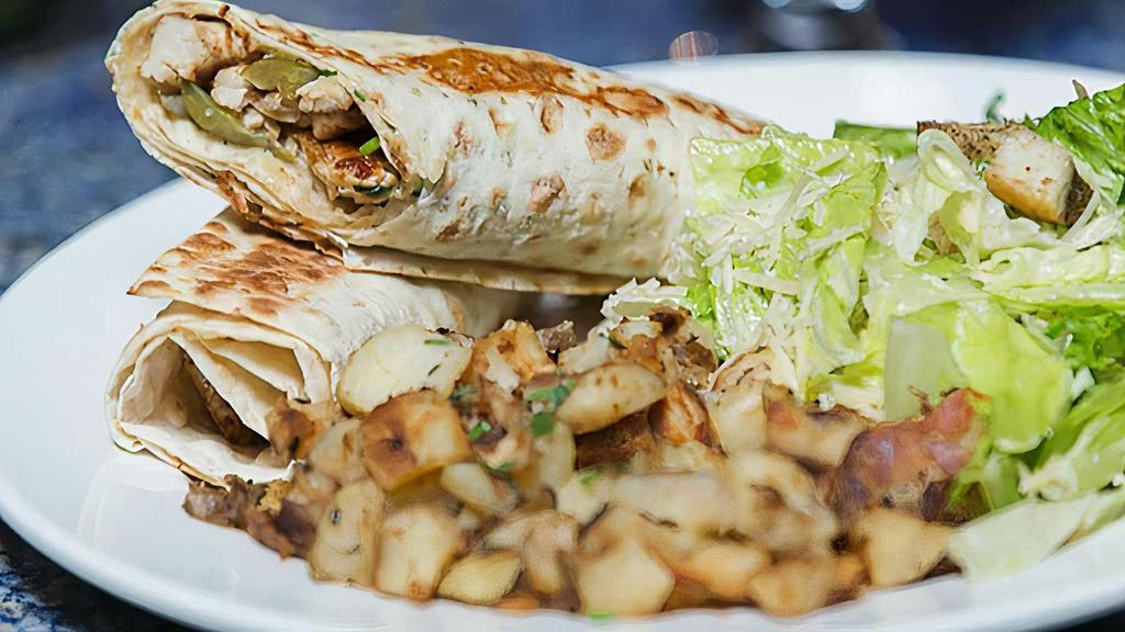 Chicken Shawerma Sandwich · Sliced chicken breast marinated and grilled, served with lavash with creamy garlic and pickles with caesar salad.
