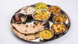 Gujrati Thali · 3 Vegetables, Rice, Daal, Roti/Puri, Sweet,  Farshan, Pickle & Raita