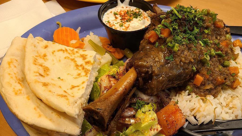 Pharaohs Lamb Shank · Homemade oven baked lamb shank cooked with veggies, served with vermicelli rice, house salad, pita & your choice of sauce.