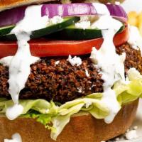 Falafel Burger · Veggie. Falafel topped with garlic eggplant, lettuce, tomatoes, onions, ketchup and tahini s...