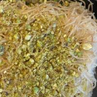 Kunafa · Sweet shredded phyllo dough stuffed with vanilla cream pudding baked then topped with pistac...