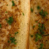 Crunchy Garlic Bread · two pieces of garlic herb baguette.