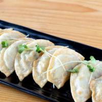 Pan Fried Dumplings · 10 pieces of house fried dumplings stuffed with chicken and various vegetables.
