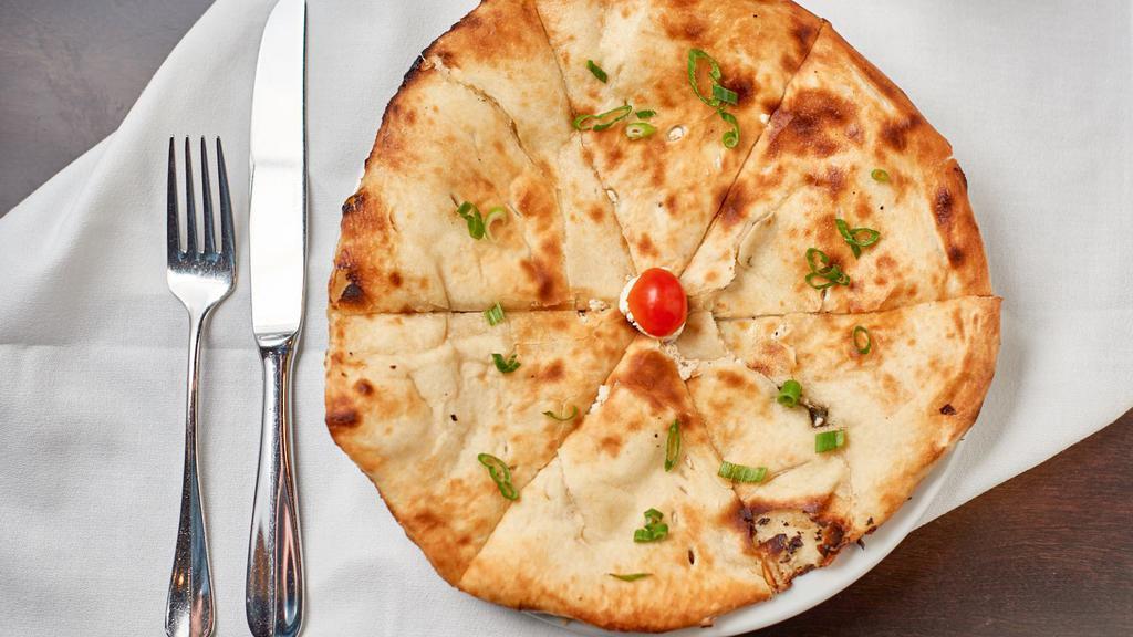 Goat Cheese Naan · Stuffed with goat cheese, green onions, and bell peppers.